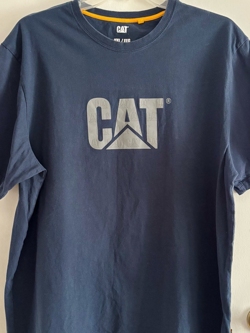 CAT or Caterpillar XXL or 2XL navy blue tshirt. Embossed or raised gray logo.